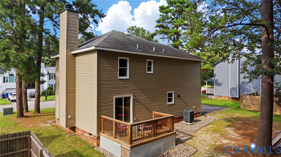 2807 Executive Drive, John Tyler Woods, Chesterfield, VA 23831 Exterior featuring horizontal siding, a tall chimney, a wood deck with railings, and a sliding glass door