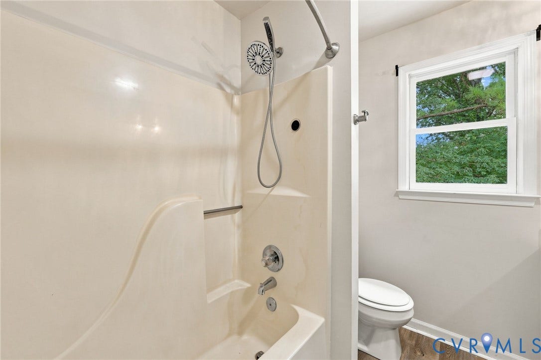 2807 Executive Drive, John Tyler Woods, Chesterfield, VA 23831 Bathtub shower combination with a handheld showerhead, chrome fixtures, and a built-in shower caddy