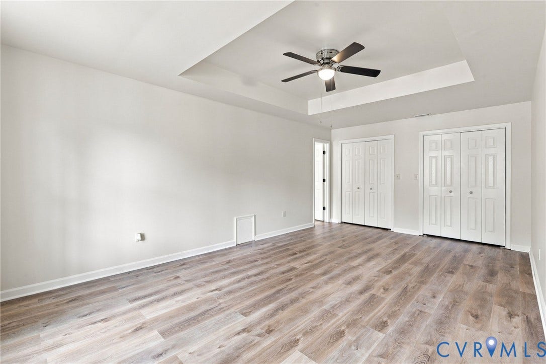 2807 Executive Drive, John Tyler Woods, Chesterfield, VA 23831 Tray ceiling with a ceiling fan, wood-finish flooring, and white bifold closet doors