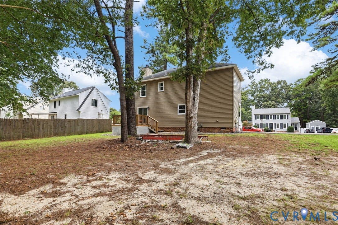 2807 Executive Drive, John Tyler Woods, Chesterfield, VA 23831 Expansive property with mature trees, a multi-level wood deck, and a privacy fence