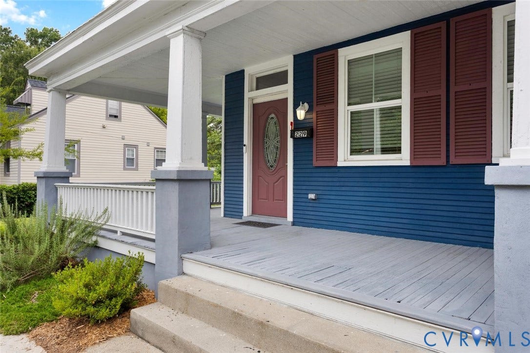 Covered front porch with painted wood flooring