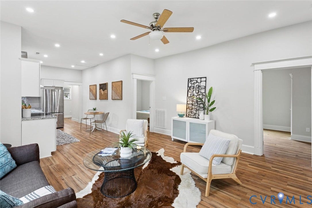 Recessed lighting, wood-finish flooring, white cabinetry, stainless steel appliances, and a ceiling fan