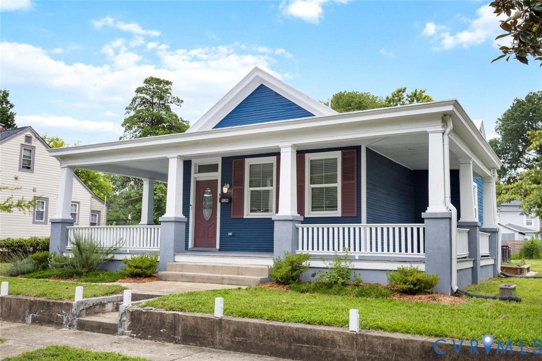 Covered front porch with white columns and railing