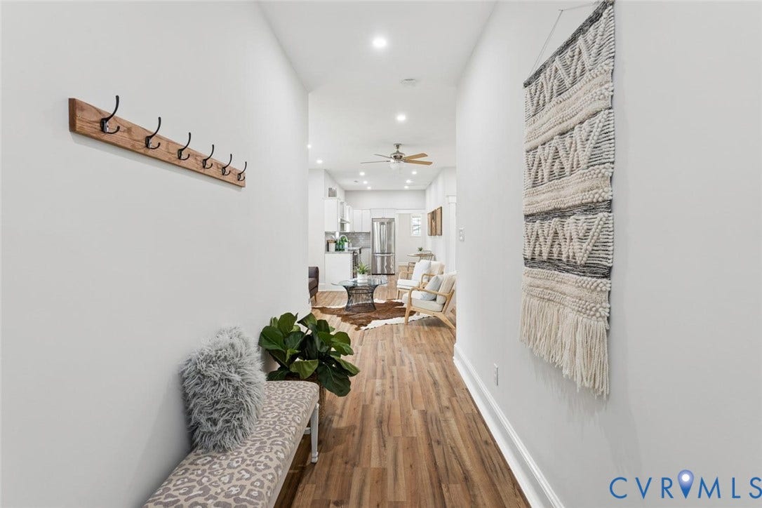Recessed lighting, wood-finish flooring, and white walls