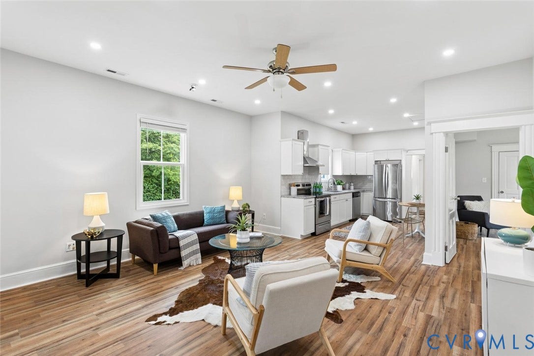 Open concept living area featuring wood-finish flooring, recessed lighting, and a ceiling fan