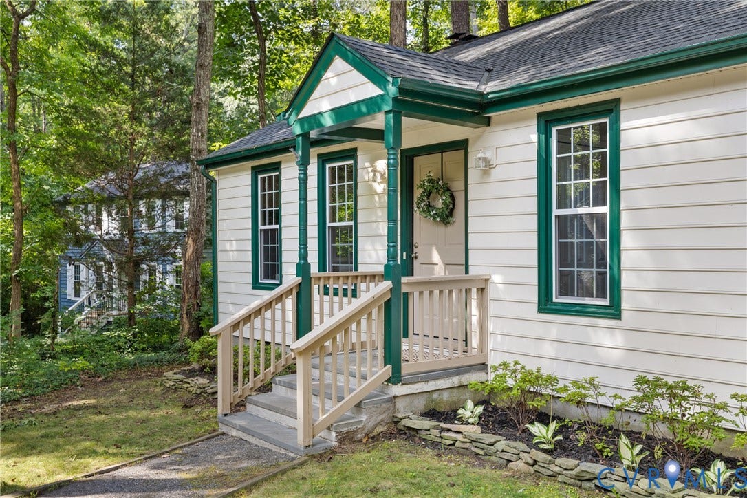 4906 Court Ridge Terrace, Brandermill, Midlothian, VA 23112 Front entrance featuring a covered porch with decorative columns, a natural wood railing, concrete steps, and a landscaped garden bed with a stone retaining wall