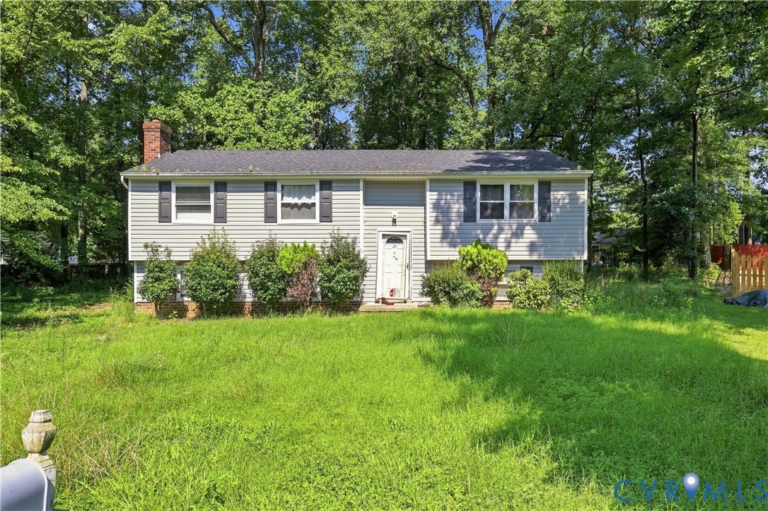 6500 Watchspring Court, Watch Run, Richmond, VA 23234 Split-level residence featuring light-colored siding, dark shutters, and a prominent brick chimney