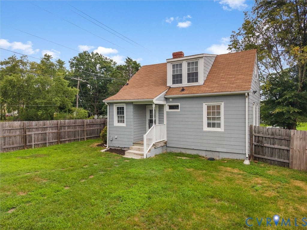 Rear exterior featuring gray siding and a dormer window