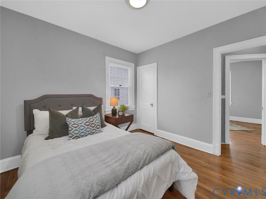 Hardwood flooring throughout, neutral wall tones, and white trim