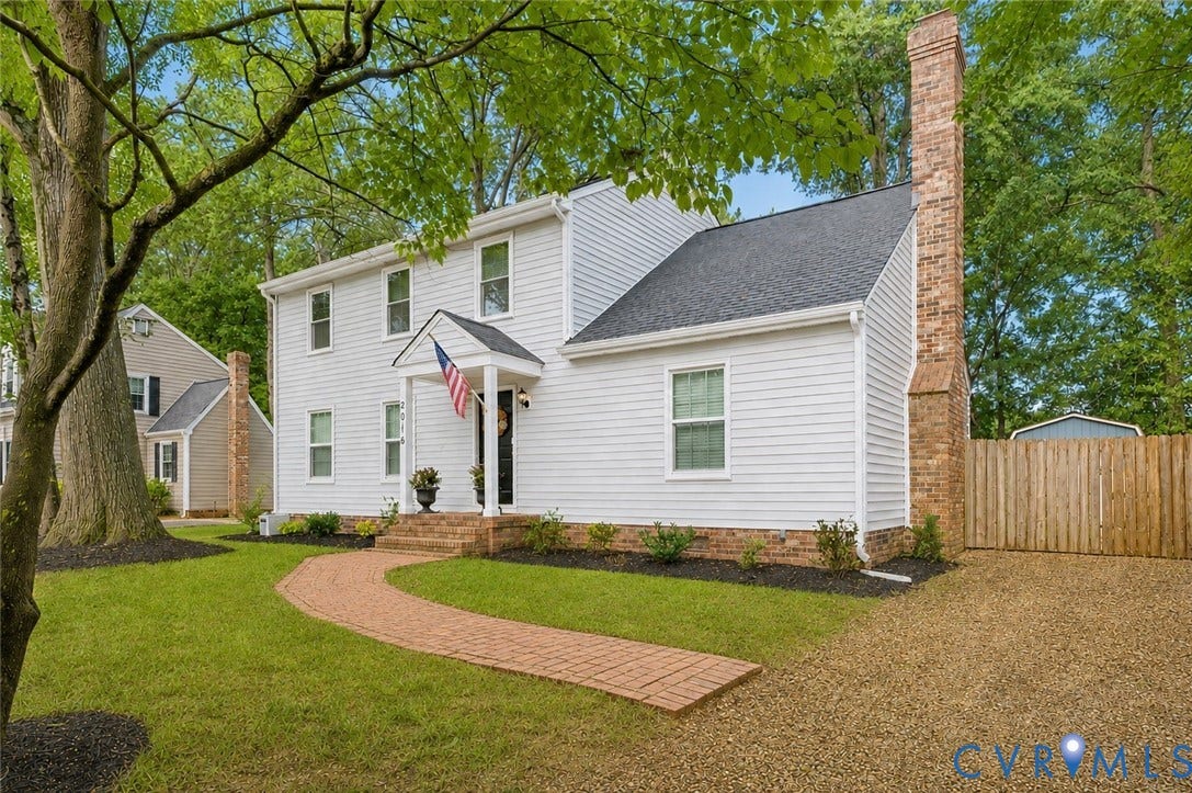 2016 Wrens Nest Road, Settlers Landing, Richmond, VA 23235 Traditional white siding exterior with a dark shingle roof, featuring a prominent brick chimney - Ai enhanced photo