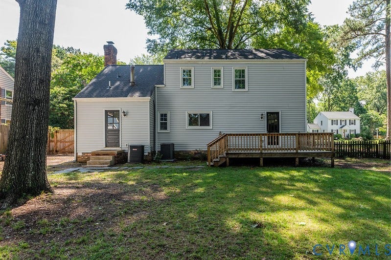 2016 Wrens Nest Road, Settlers Landing, Richmond, VA 23235 Expansive backyard with a wooden deck, mature trees, and a partial privacy fence