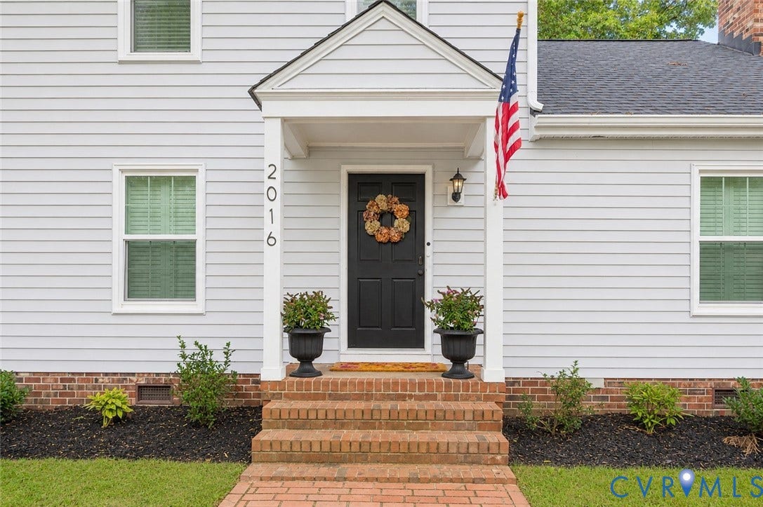 2016 Wrens Nest Road, Settlers Landing, Richmond, VA 23235 Light-colored horizontal siding facade with a dark entry door and a covered portico - Ai Enhanced Image