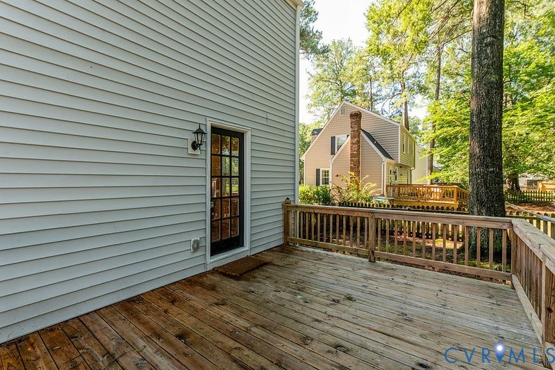 2016 Wrens Nest Road, Settlers Landing, Richmond, VA 23235 Wood deck with wood railing, leading to an exterior door with multiple lites, featuring a wall-mounted light fixture, and horizontal siding