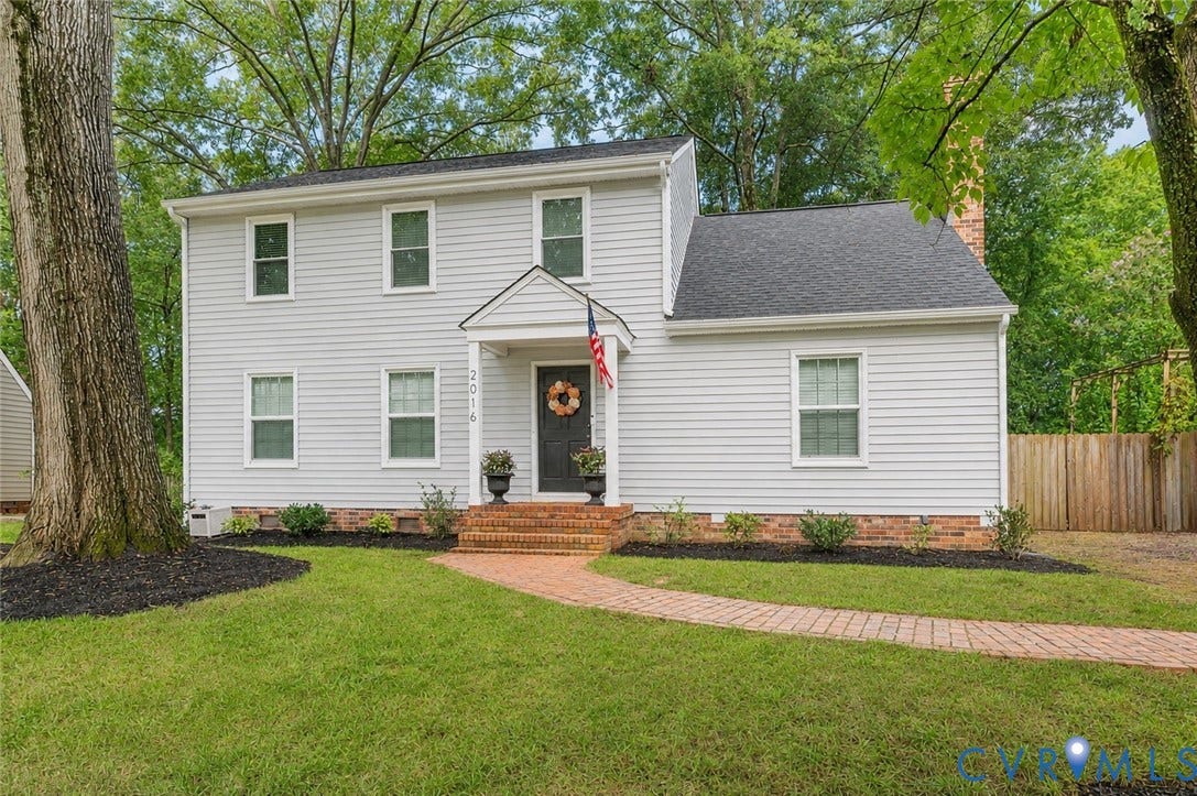 2016 Wrens Nest Road, Settlers Landing, Richmond, VA 23235 Two-story residence featuring light-colored siding, a dark asphalt shingle roof, and multiple windows - Ai enhanced photo