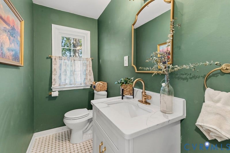 2016 Wrens Nest Road, Settlers Landing, Richmond, VA 23235 White vanity with an integrated sink and gold-finish faucet