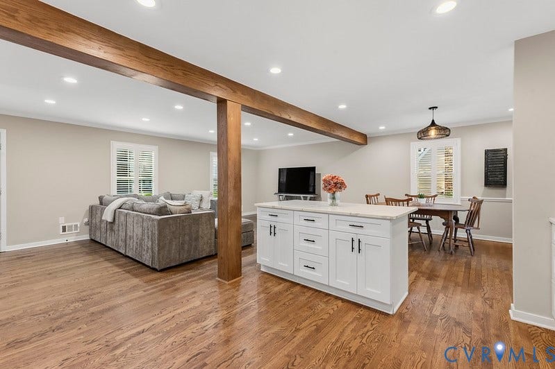 2016 Wrens Nest Road, Settlers Landing, Richmond, VA 23235 Hardwood flooring, white kitchen island with countertop, recessed lighting, exposed wood beam, and white window shutters