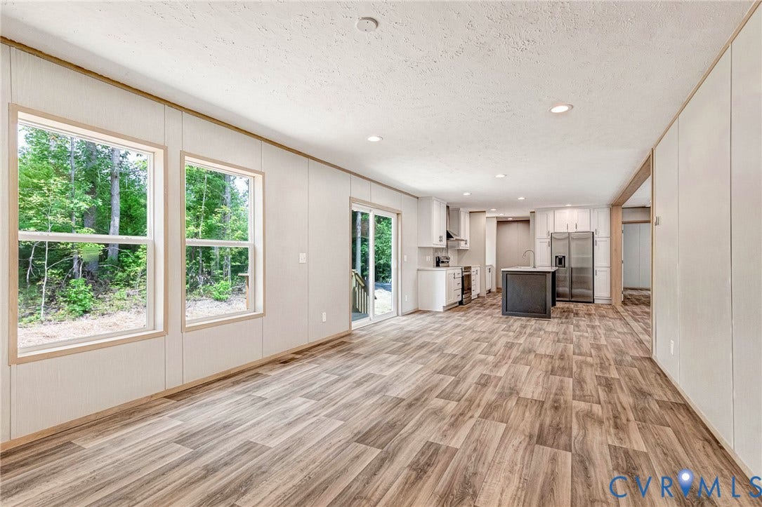 15263 Cross County Road, Mineral, VA 23117 Expansive living area with wood-finish flooring, two large windows, and recessed lighting