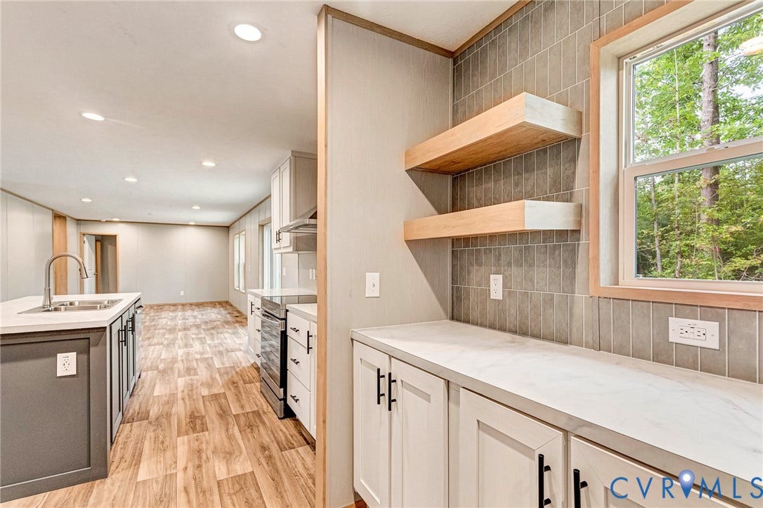 15263 Cross County Road, Mineral, VA 23117 Kitchen featuring white cabinetry with black hardware, wood-finish flooring, recessed lighting, and a window with wood trim