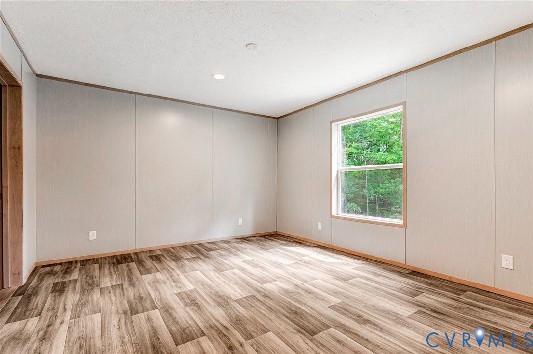 15263 Cross County Road, Mineral, VA 23117 Wood-finish flooring with light-colored panel walls and a recessed ceiling light