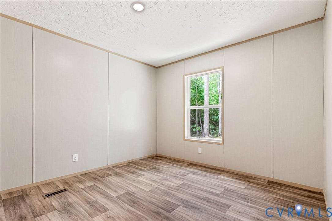 15263 Cross County Road, Mineral, VA 23117 Wood-finish flooring, recessed ceiling light, paneled walls, and a double-hung window
