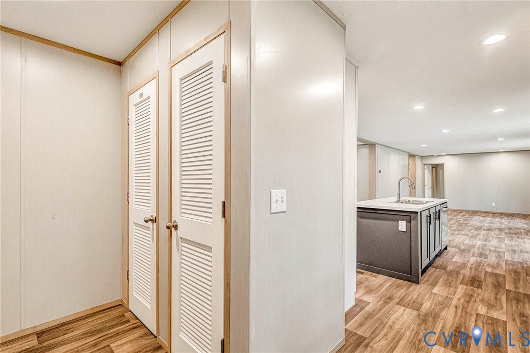 15263 Cross County Road, Mineral, VA 23117 Wood-finish flooring throughout, two louvered doors, and a kitchen island with a sink and overhead lighting