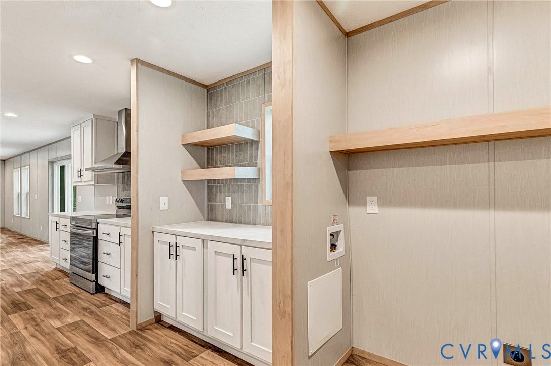 15263 Cross County Road, Mineral, VA 23117 Kitchen featuring wood-finish flooring, white cabinetry, a stainless steel range with hood, and recessed lighting