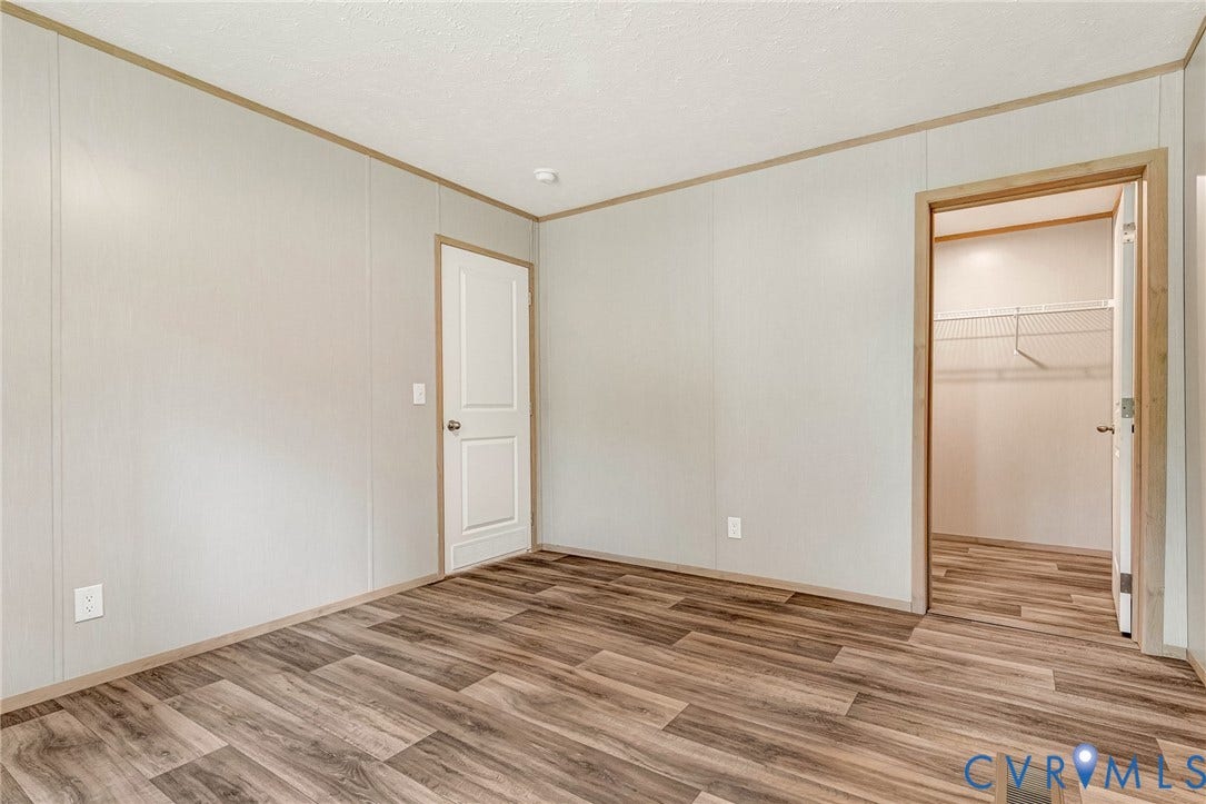 15263 Cross County Road, Mineral, VA 23117 Wood-finish flooring, white paneling, and an open closet with wire shelving