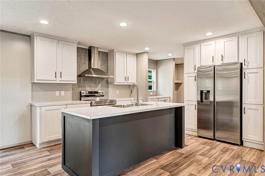 15263 Cross County Road, Mineral, VA 23117 Kitchen featuring white shaker-style cabinetry, a gray kitchen island with a light-colored countertop, stainless steel appliances, and wood-finish flooring