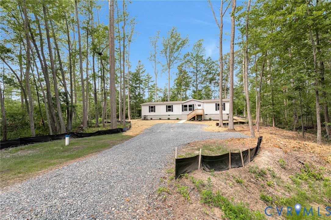 15263 Cross County Road, Mineral, VA 23117 Single-story residence with light-colored siding and dark shutters