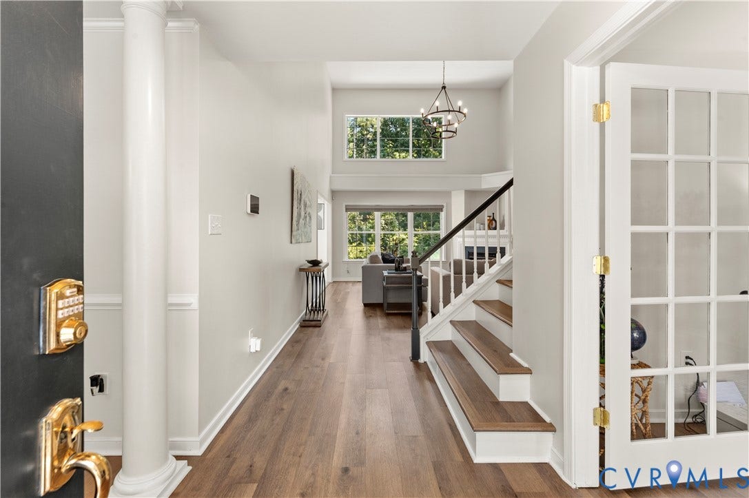 Looking inside from the front door. Office to the right, dining room to the left, and family room straight ahead.