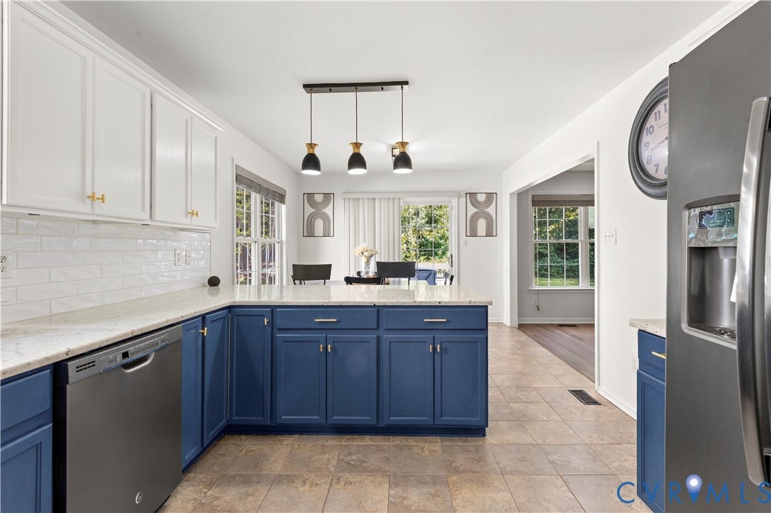 Kitchen has new fixtures, appliances, granite countertops, fresh paint and subway tiled backsplash.