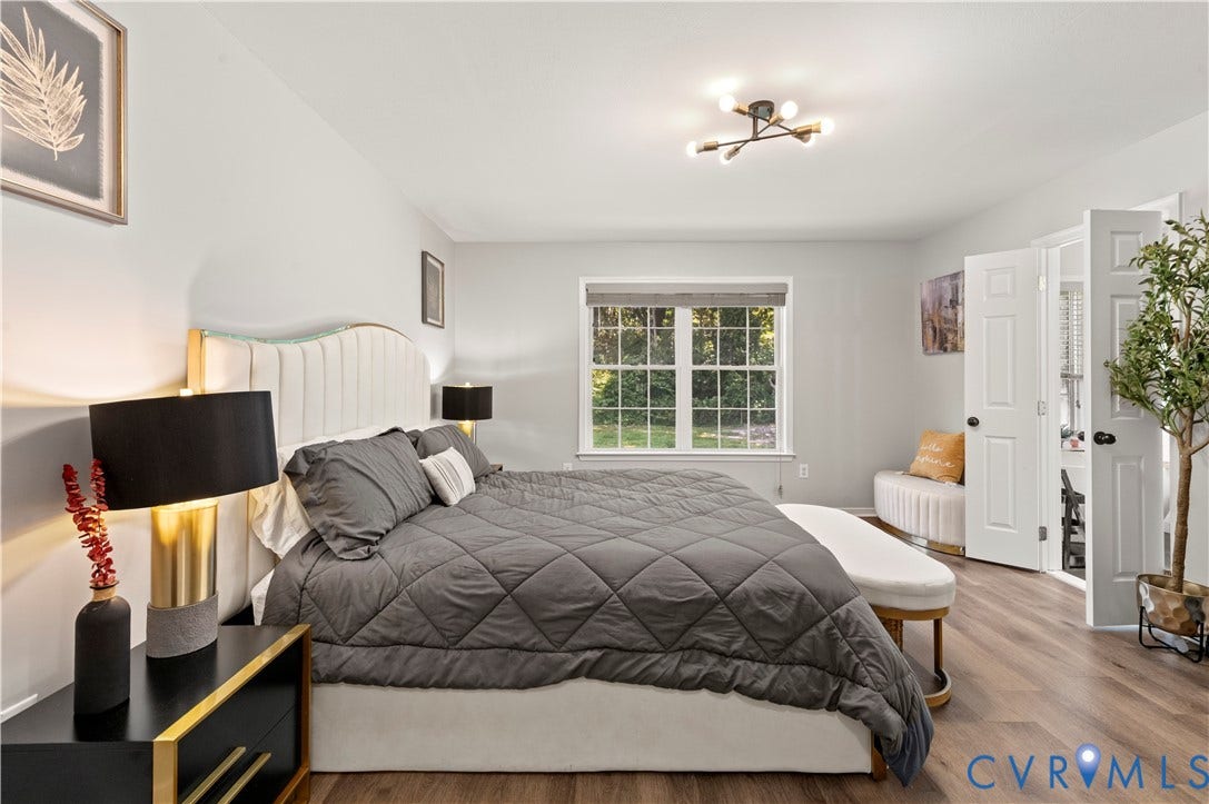 Owner's suite with new flooring, fixture and paint. Spa bath to the right with double doors.