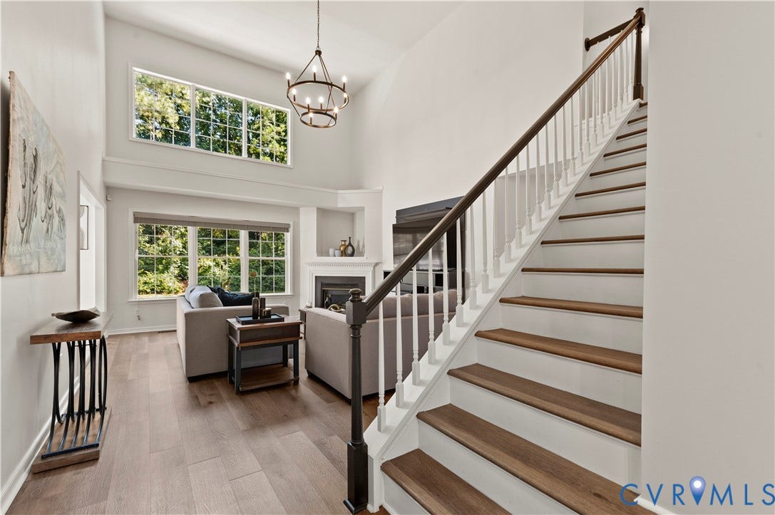 Cathedral ceiling in the family room with new light fixture and wall of windows.