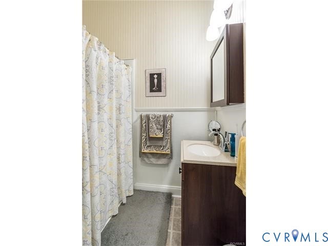 1524 Grove Avenue, Richmond, VA 23220 Dark wood-finish vanity with an undermount sink and light-toned countertop