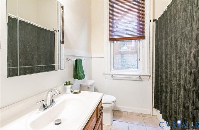 1524 Grove Avenue, Richmond, VA 23220 White vanity with integrated sink, chrome faucet, and wood-finish cabinetry