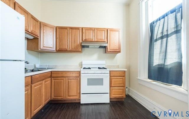 1524 Grove Avenue, Richmond, VA 23220 Kitchen featuring wood-finish cabinetry, light-toned countertops, a white refrigerator, a white range with hood, and dark wood-finish flooring