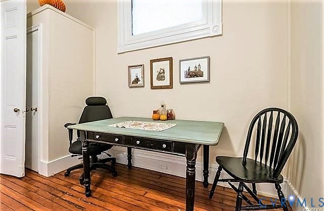 1524 Grove Avenue, Richmond, VA 23220 Hardwood flooring, painted interior walls, and a window with trim