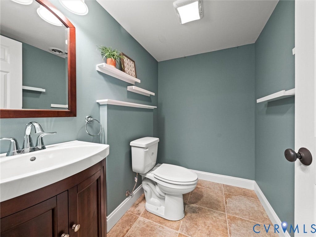 6126 Cartersville Road, Powhatan, VA 23139 Bathroom with a wood-finish vanity, chrome fixtures, ceramic tile flooring, and integrated wall shelving