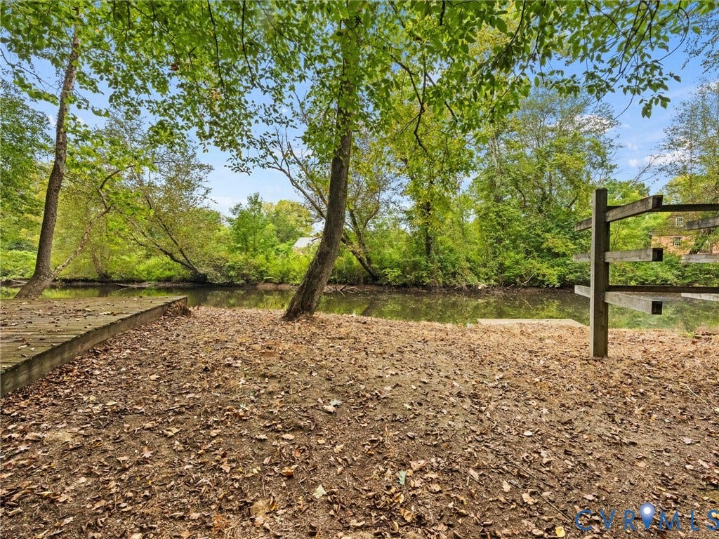 6126 Cartersville Road, Powhatan, VA 23139 Waterfront property featuring a wooden dock, mature trees, and natural landscaping