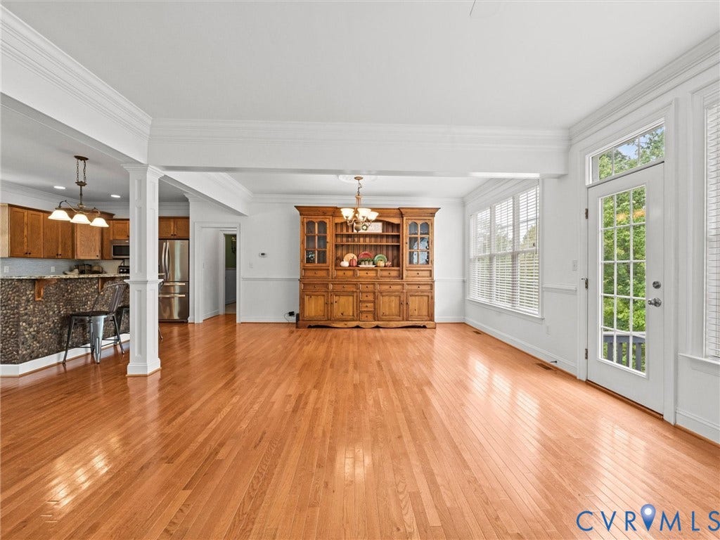 6126 Cartersville Road, Powhatan, VA 23139 Hardwood flooring throughout, with a sunroom featuring multiple windows and a glass-paneled door