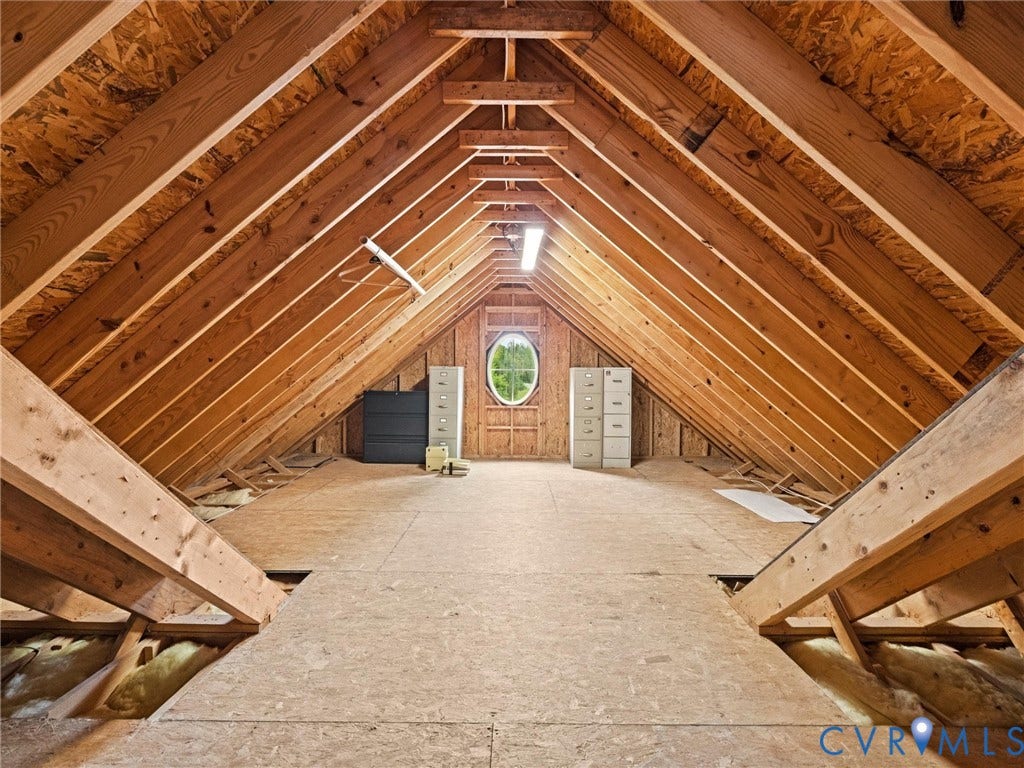 6126 Cartersville Road, Powhatan, VA 23139 Exposed wood beam ceiling with a central oval window and wood-finish flooring