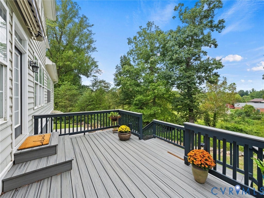6126 Cartersville Road, Powhatan, VA 23139 Expansive outdoor deck with composite decking, dark railings, and a serene tree-lined backdrop