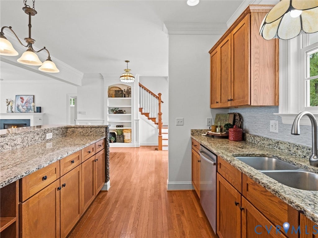 6126 Cartersville Road, Powhatan, VA 23139 Kitchen featuring wood cabinetry, granite countertops, an undermount double basin sink, and a stainless steel dishwasher