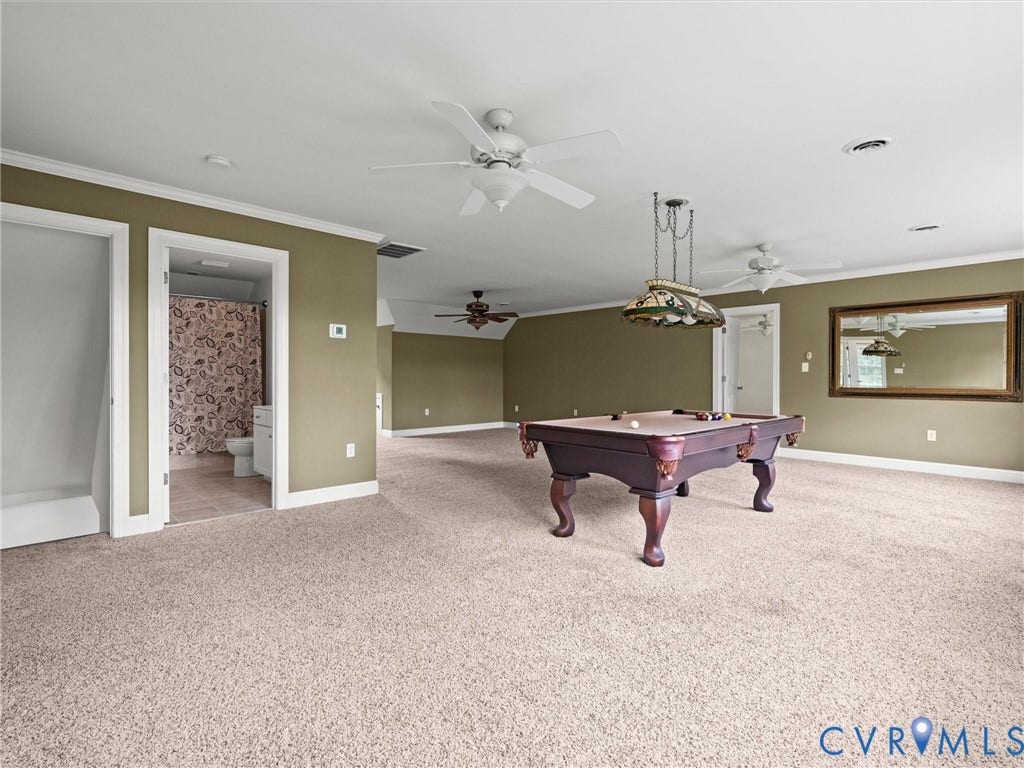 6126 Cartersville Road, Powhatan, VA 23139 Expansive carpeted room with multiple ceiling fans, crown molding, and a built-in bathroom
