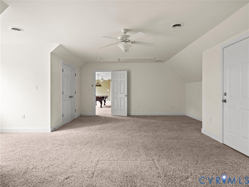 6126 Cartersville Road, Powhatan, VA 23139 Carpeted room with a ceiling fan, sloped ceilings, and two white doors