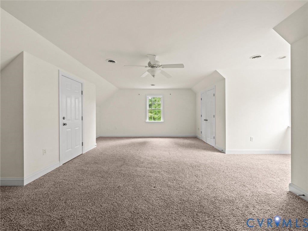 6126 Cartersville Road, Powhatan, VA 23139 Vaulted ceiling with a ceiling fan, window with exterior views, and neutral carpet flooring