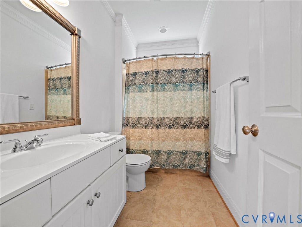 6126 Cartersville Road, Powhatan, VA 23139 White vanity with integrated sink, polished chrome faucet, and matching decorative mirror