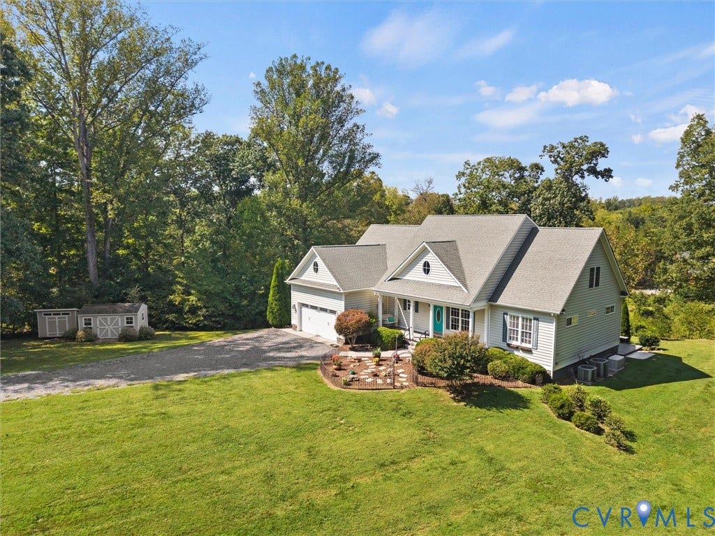 6126 Cartersville Road, Powhatan, VA 23139 Light blue siding exterior with a white trim, an attached two-car garage, and a gravel driveway