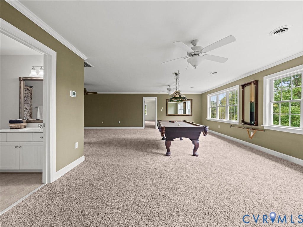 6126 Cartersville Road, Powhatan, VA 23139 Expansive carpeted room featuring multiple windows, crown molding, and ceiling fans