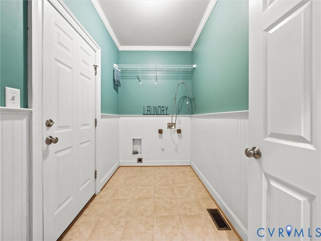 6126 Cartersville Road, Powhatan, VA 23139 Laundry area featuring tile flooring, wainscoting, crown molding, and a wire shelving unit
